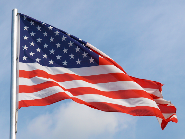 United States flag against blue sky