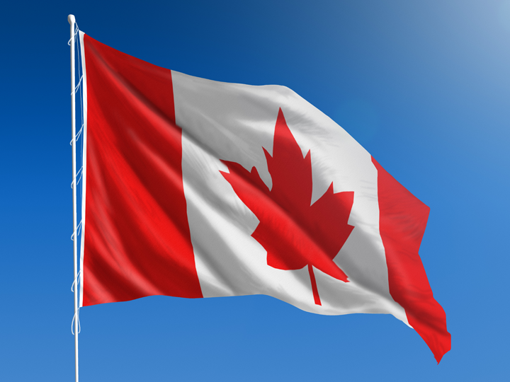 Canada flag against blue sky