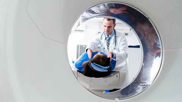 Doctor talking with patient before MRI scan