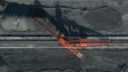 Aerial image directly above an industrial machine working in a coal pit
