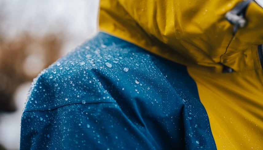 Detail photo of wateproof jacket with water droplets on it.