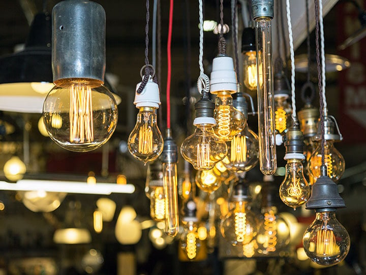 View of multiple Edison-style lightbulbs hanging from a ceiling