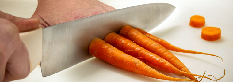 Knife cutting a carrot