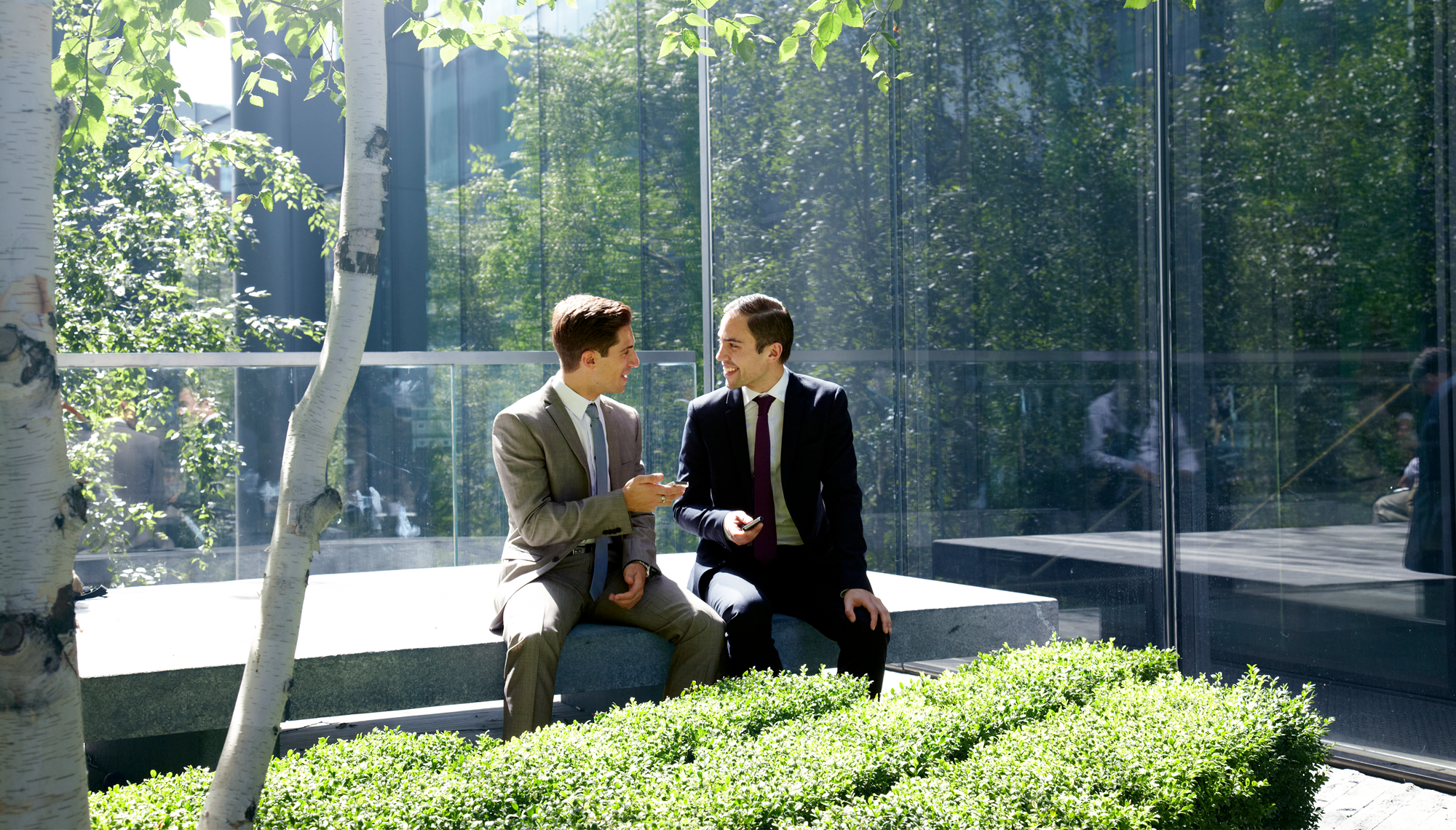 Professionals in a conference room discussing and shaking hands