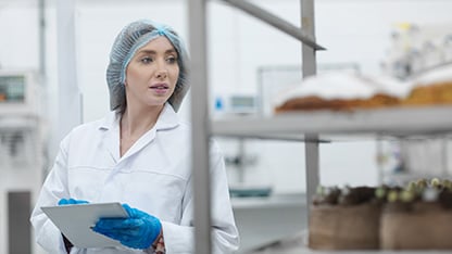 Female food safety expert monitoring production