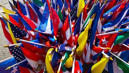 The image is a group of flags arranged in a pinwheel shape outdoors.