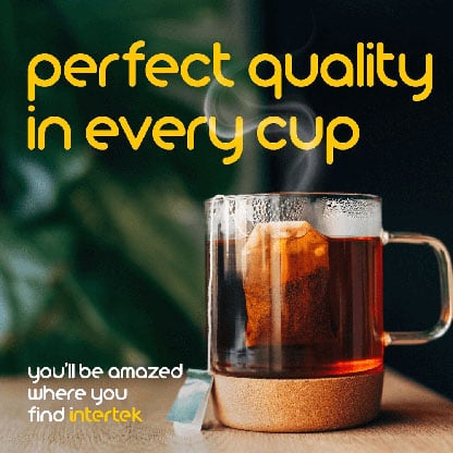 Clear cup of steaming tea with a teabag visible inside