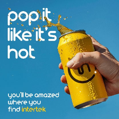 Yellow can of soda with drink spilling out while being held
